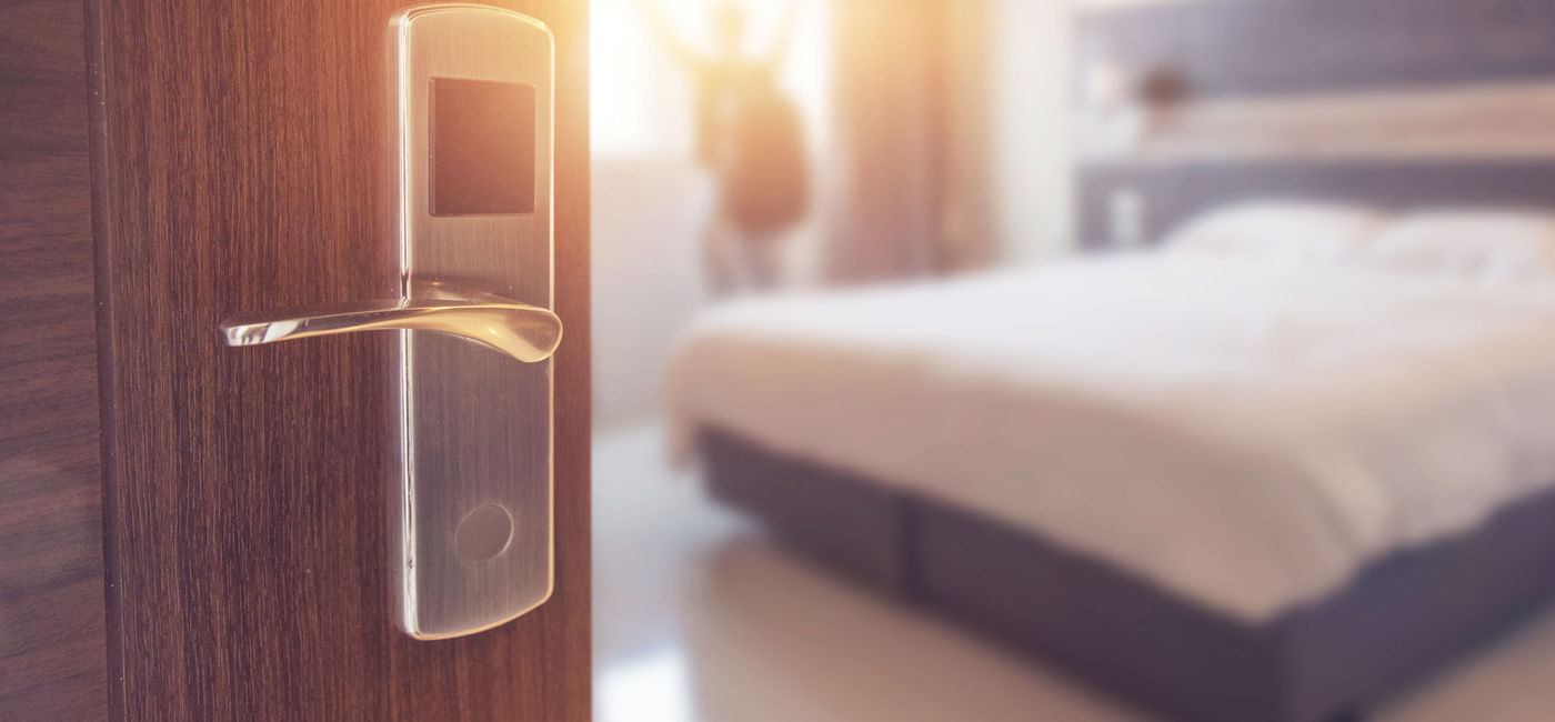Image: Opened door of hotel room in morning. (photo via oatawa / iStock / Getty Images Plus)