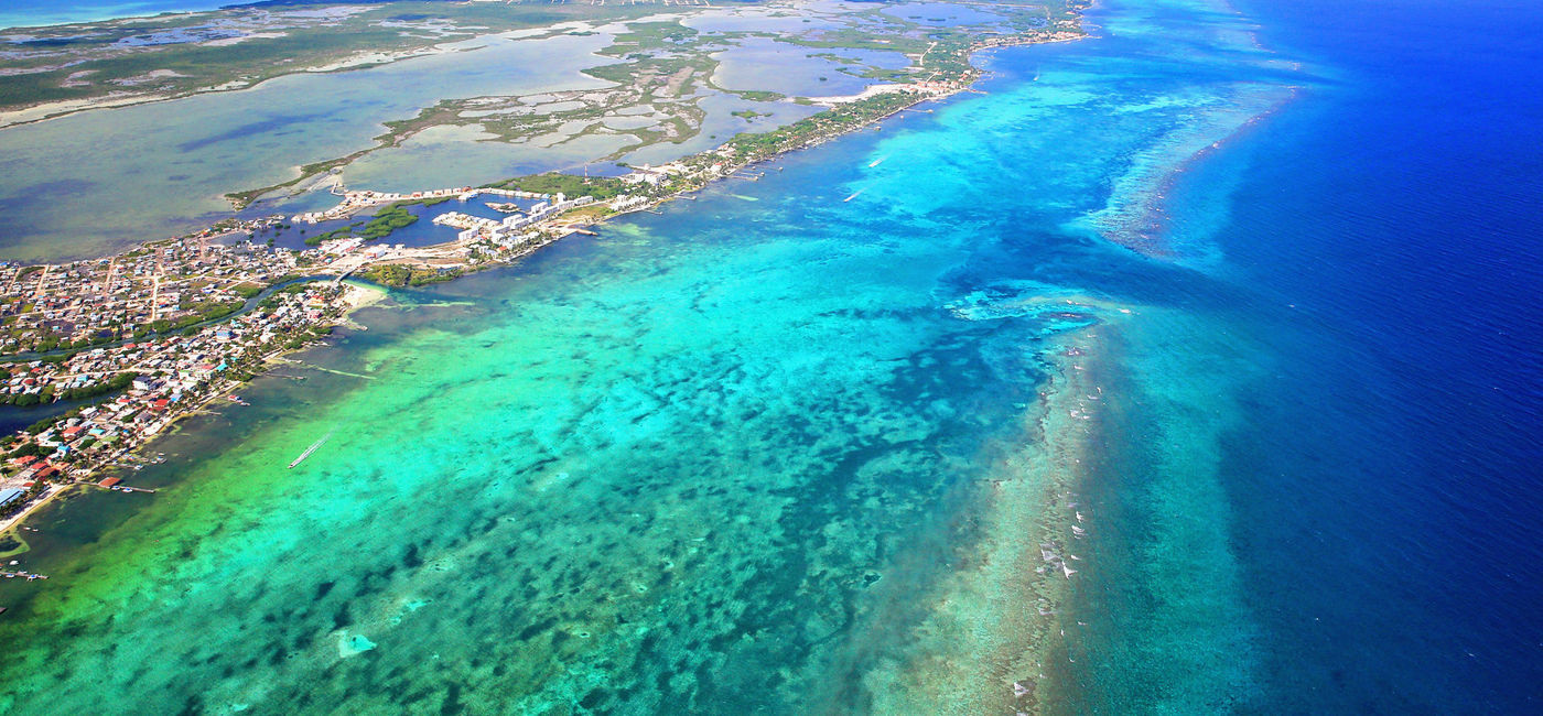Image: San Pedro Town on Ambergris Caye, Belize, and the Belize Barrier Reef beyond. (photo via iStock/Getty Images Plus/Oli Eva)