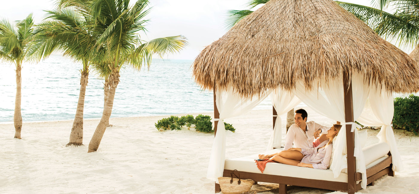 Image: A couple relaxing at Excellence Playa Mujeres. (photo via The Excellence Collection)