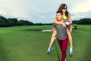 A couple golfing on vacation