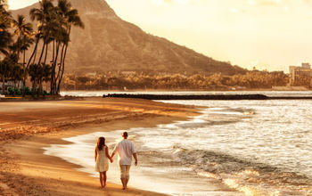 Couple walking on Waikiki Beach, Honolulu, Hawaii.