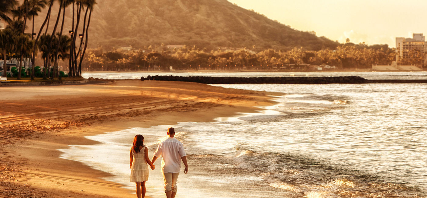 Image: Couple walking on Waikiki Beach, Honolulu, Hawaii. (Photo via IStock/Getting Images E+/jhorrocks)