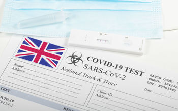 COVID-19 lateral flow test and result form with U.K. flag.