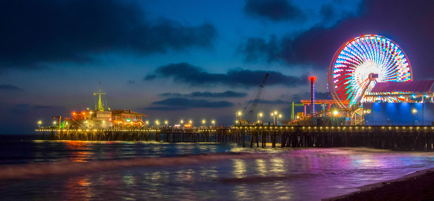 Image: Santa Monica Pier at night. (Photo via iStock / Getty Images Plus / Ershov_Maks)