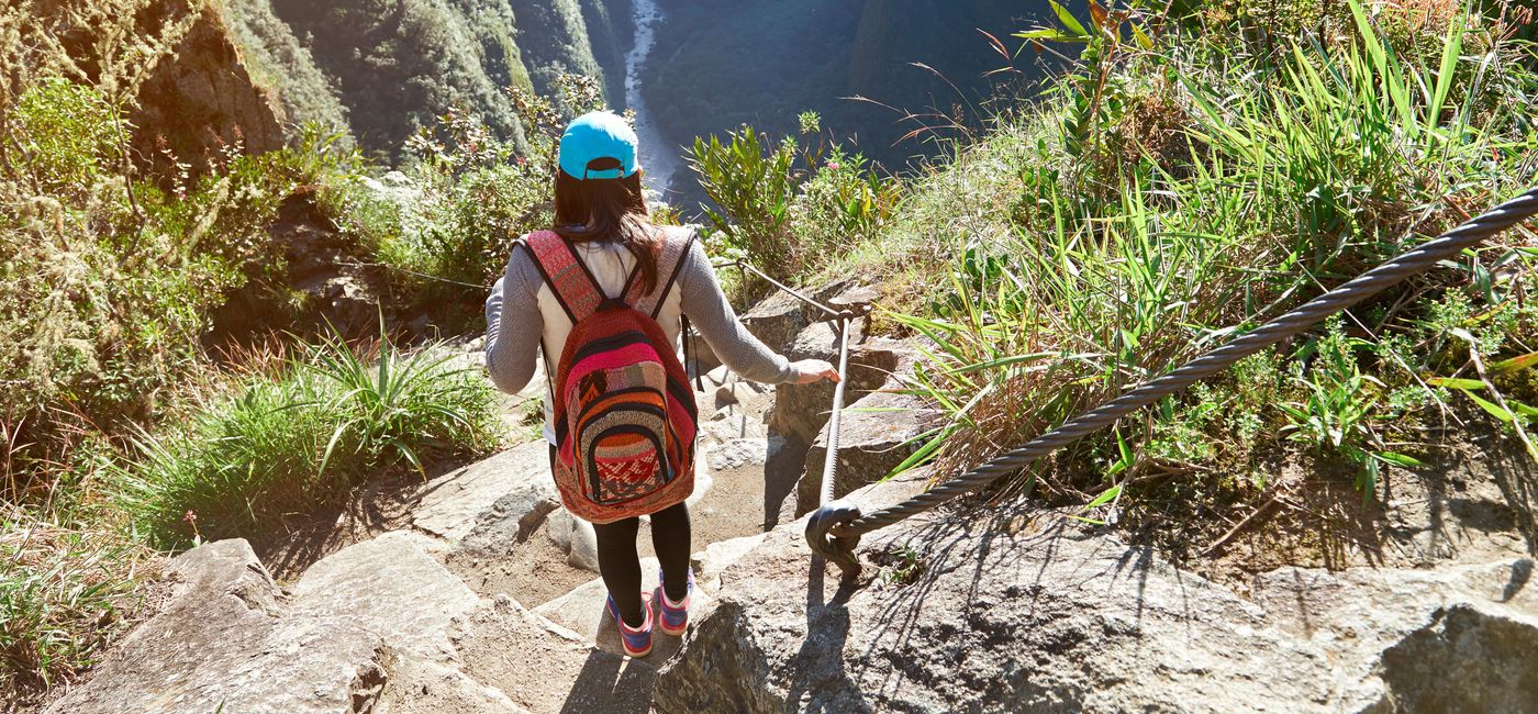 Photo: Woman trekking the Inca Trail to Machu Picchu. (photo via dimarik/iStock/Getty Images Plus)