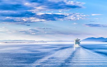 Path on the water from a large cruise ship