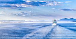 Path on the water from a large cruise ship