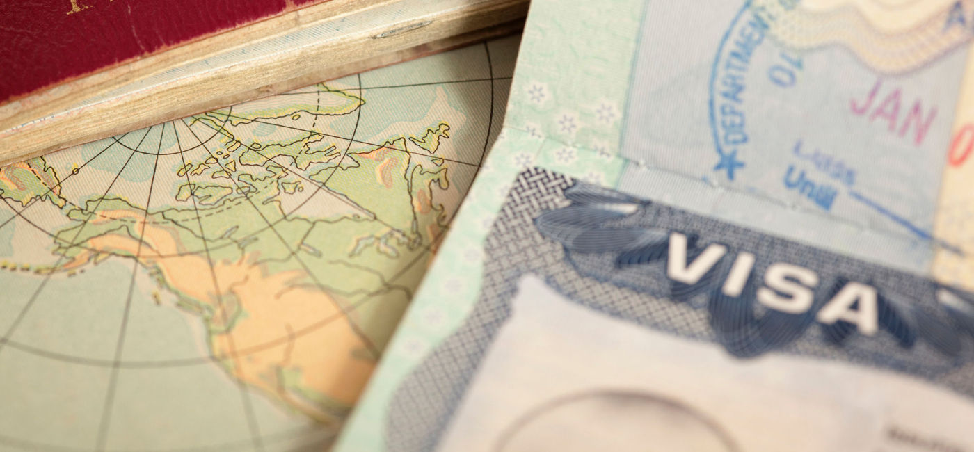 Image: U.S. and U.K. passports on a vintage world map. (photo via iStock/Getty Images E+/belterz)