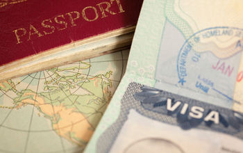 U.S. and U.K. passports on a vintage world map.