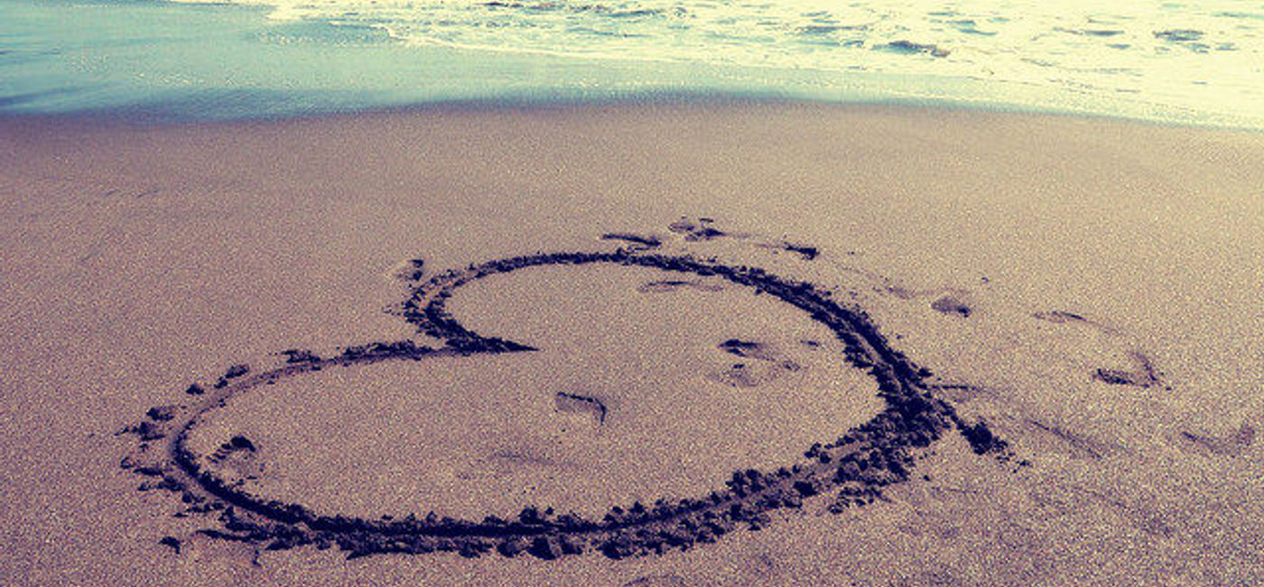 Image: PHOTO: A heart drawn in sand on a beach. (photo via Flickr/Pedro Fernandes)