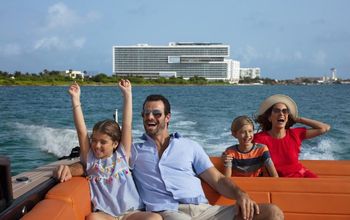 Family enjoying a boat ride from Dreams Vista Cancun Golf & Spa Resort