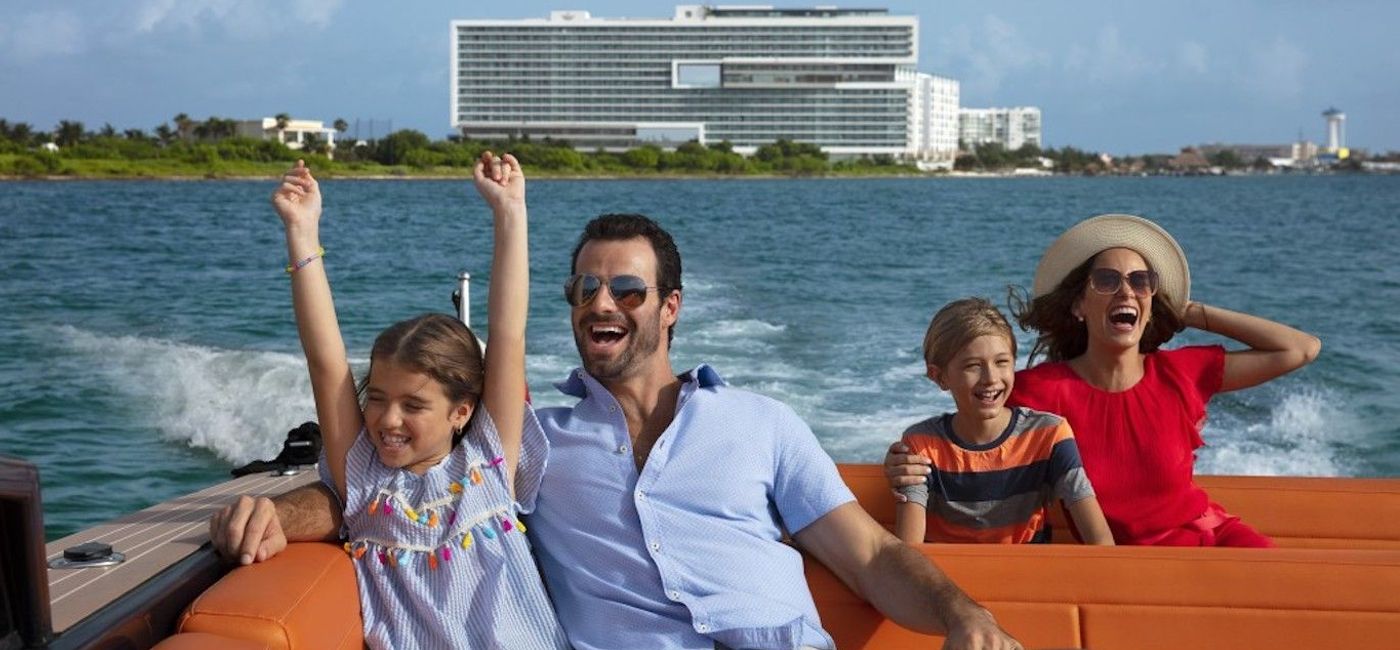 Photo: Family enjoying a boat ride from Dreams Vista Cancun Golf & Spa Resort. (photo courtesy of AMResorts)
