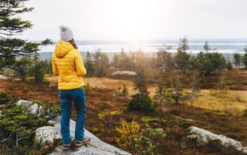 Woman traveler in yellow puffer jacket