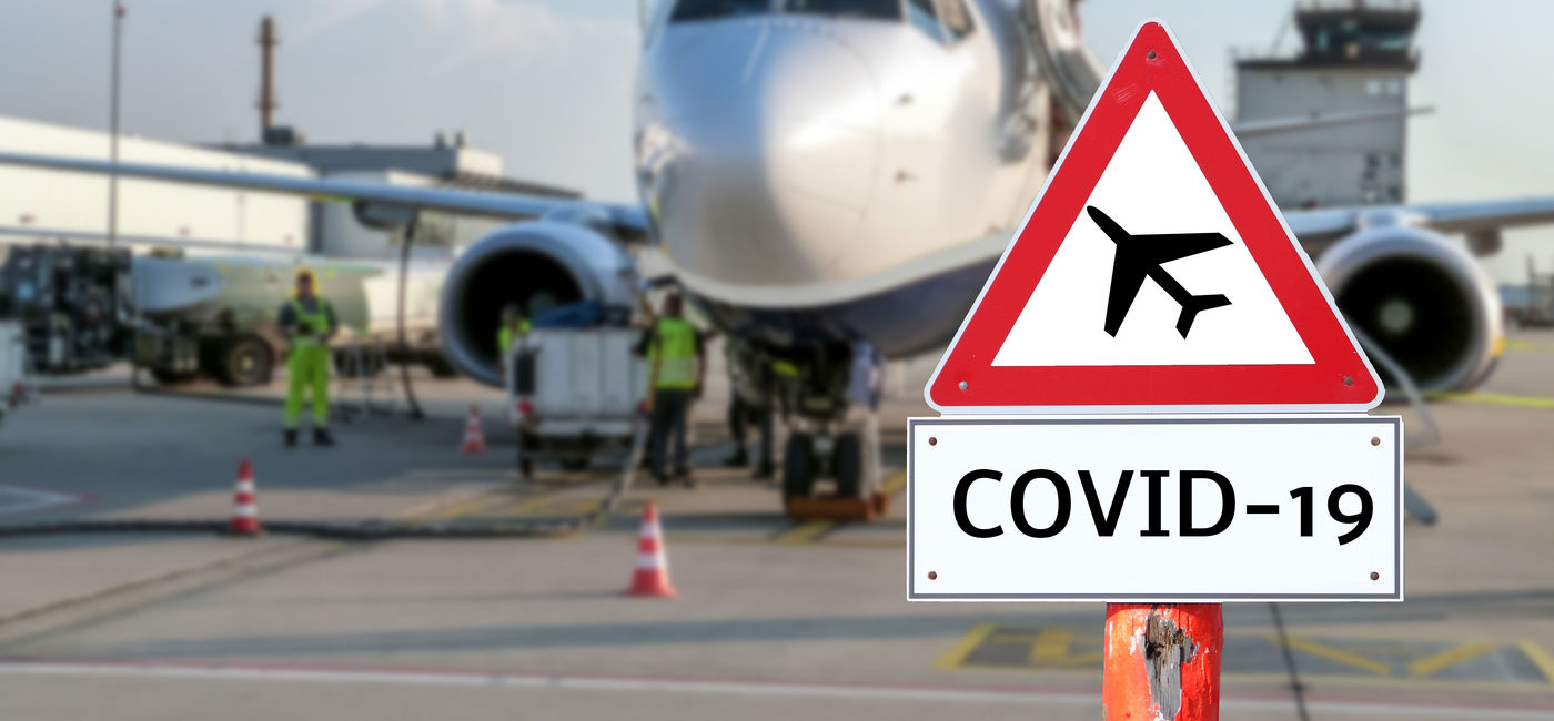 Image: Coronavirus sign at an airport. (photo via Animaflora / iStock / Getty Images Plus)