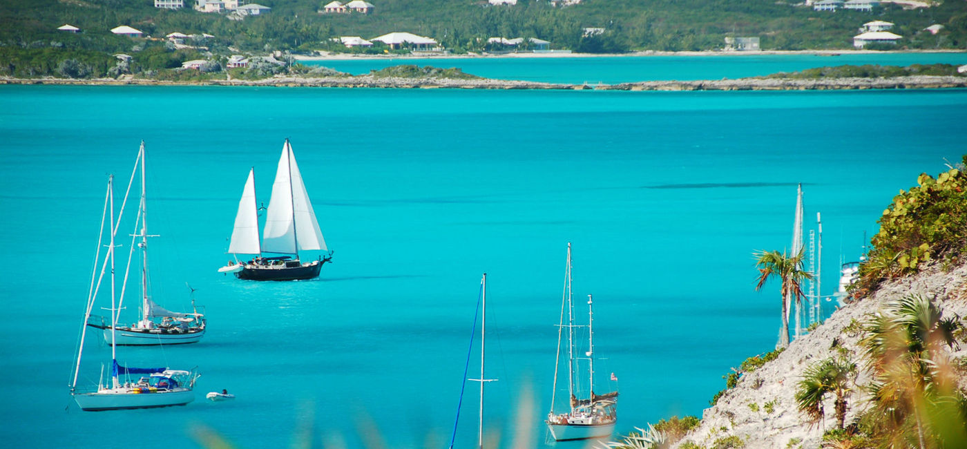 Image: PHOTO: Sailboats passing Stocking Island, Exuma, The Bahamas. (Photo via iStock/Getty Images E+/Wildroze)