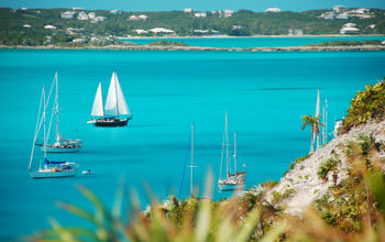 Sailboats passing Stocking Island, Exuma, The Bahamas.