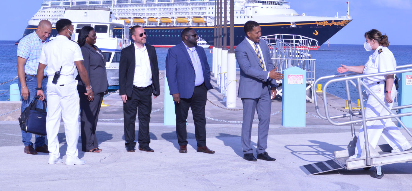 Image: Kenneth Bryan, the Cayman Islands’ minister of tourism and transport, welcomes Disney Cruise Line staff to the Cayman Islands. (photo courtesy of Cayman Islands Department of Tourism)