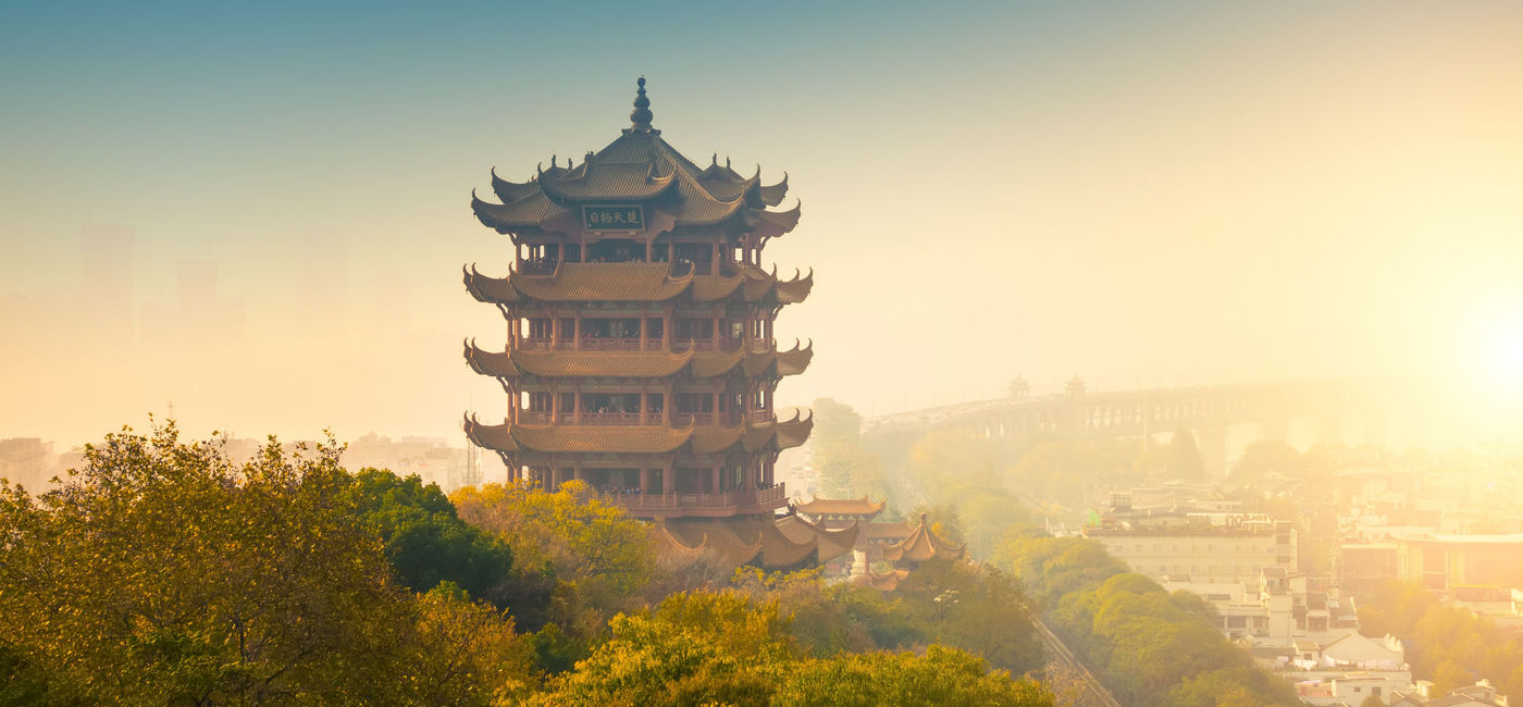 Image: PHOTO: Yellow crane tower at sunset in Wuhan city. (Photo via Getty Images Plus / iStock / xijian)