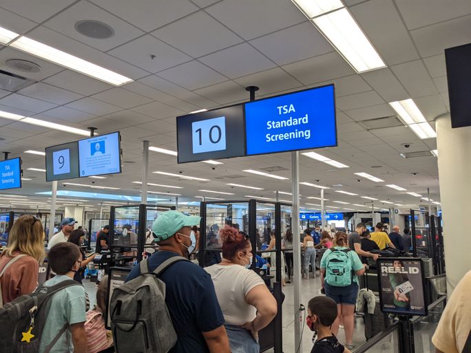TSA security line, TSA security, TSA, Orlando Airport, Face Mask, travelers, airport crowd
