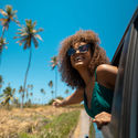 Woman leaning out the window as she travels