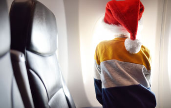 Young child on an airplane during holiday season.
