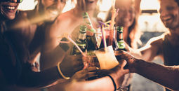 Friends toasting with alcohol at sunset
