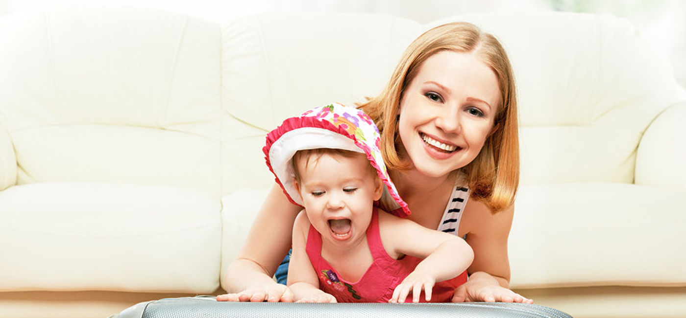 Image: PHOTO: A baby girl helps mom pack a suitcase. (photo courtesy of Thinkstock)