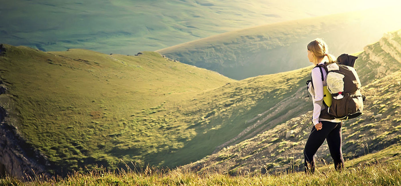Image: PHOTO: Woman Traveler with Backpack hiking in Mountains. (photo courtesy of Thinkstock)