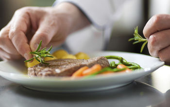 Chef garnishing entree