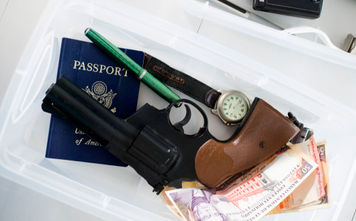 Gun in airport screening tray.