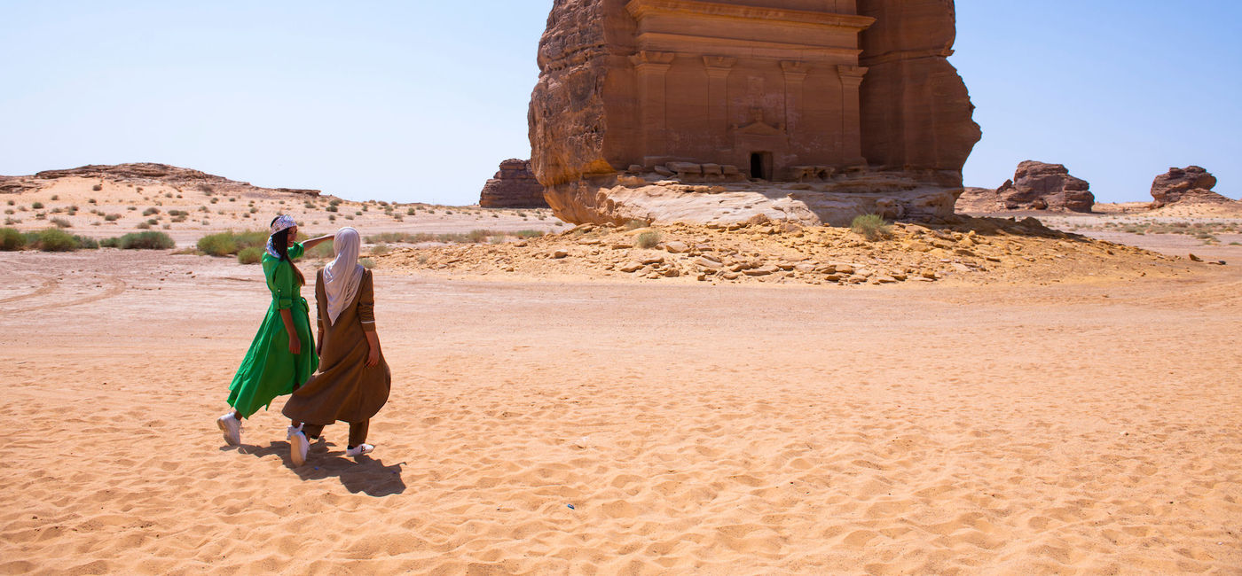 Image: Travelers exploring Hegra in AlUla. (photo courtesy of Saudi Tourism Authority)