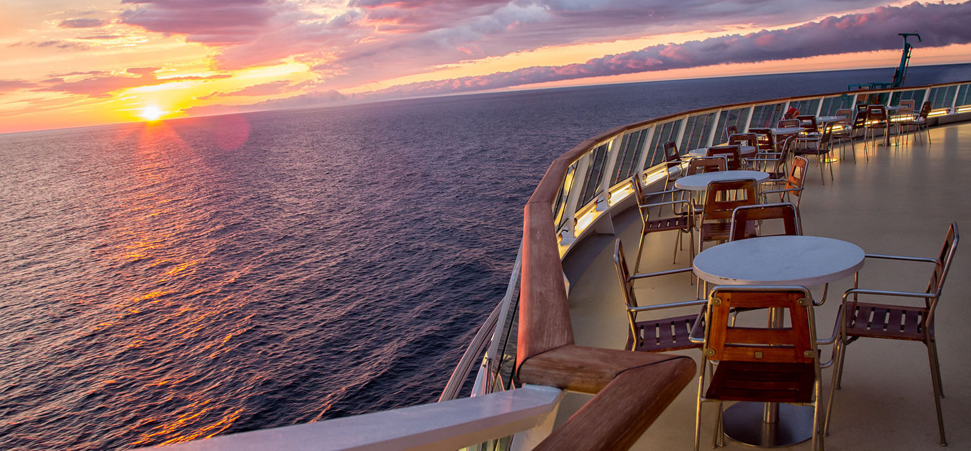 Image: PHOTO: Cruise ship deck at sunset. (photo courtesy grandriver/E+/Getty Images)