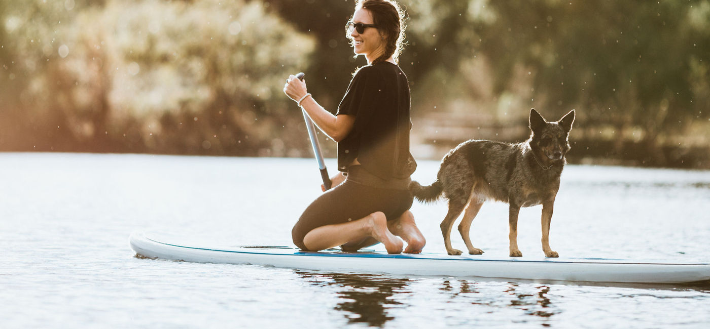 Photo: Woman paddle boarding with her dog in Austin, Texas. (photo via RyanJLane/E+)