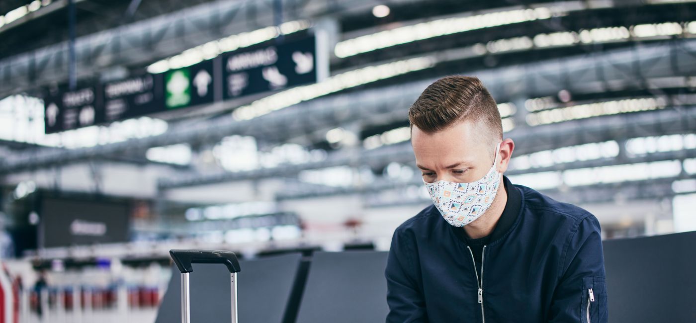 Image: Wearing a mask while traveling at the airport (photo via  Chalabala / iStock / Getty Images Plus)