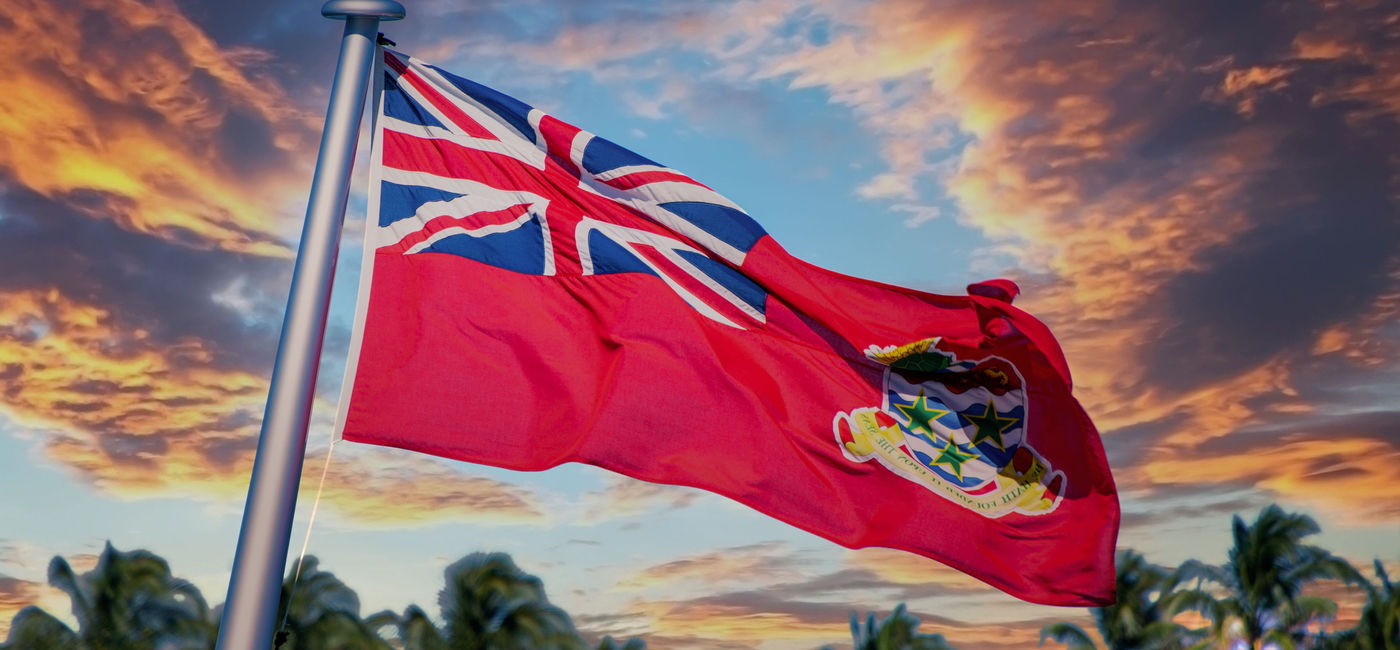 Image: Cayman Islands flag at sunset. (photo via iStock/Getty Images Plus/dbvirago)