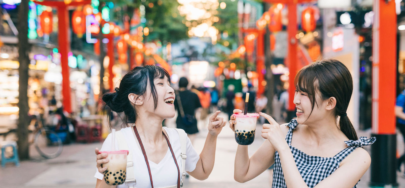 Image: Two women drink boba, or bubble tea, in Taipei, Taiwan. (photo via visualspace / E+) ((photo via visualspace / E+))