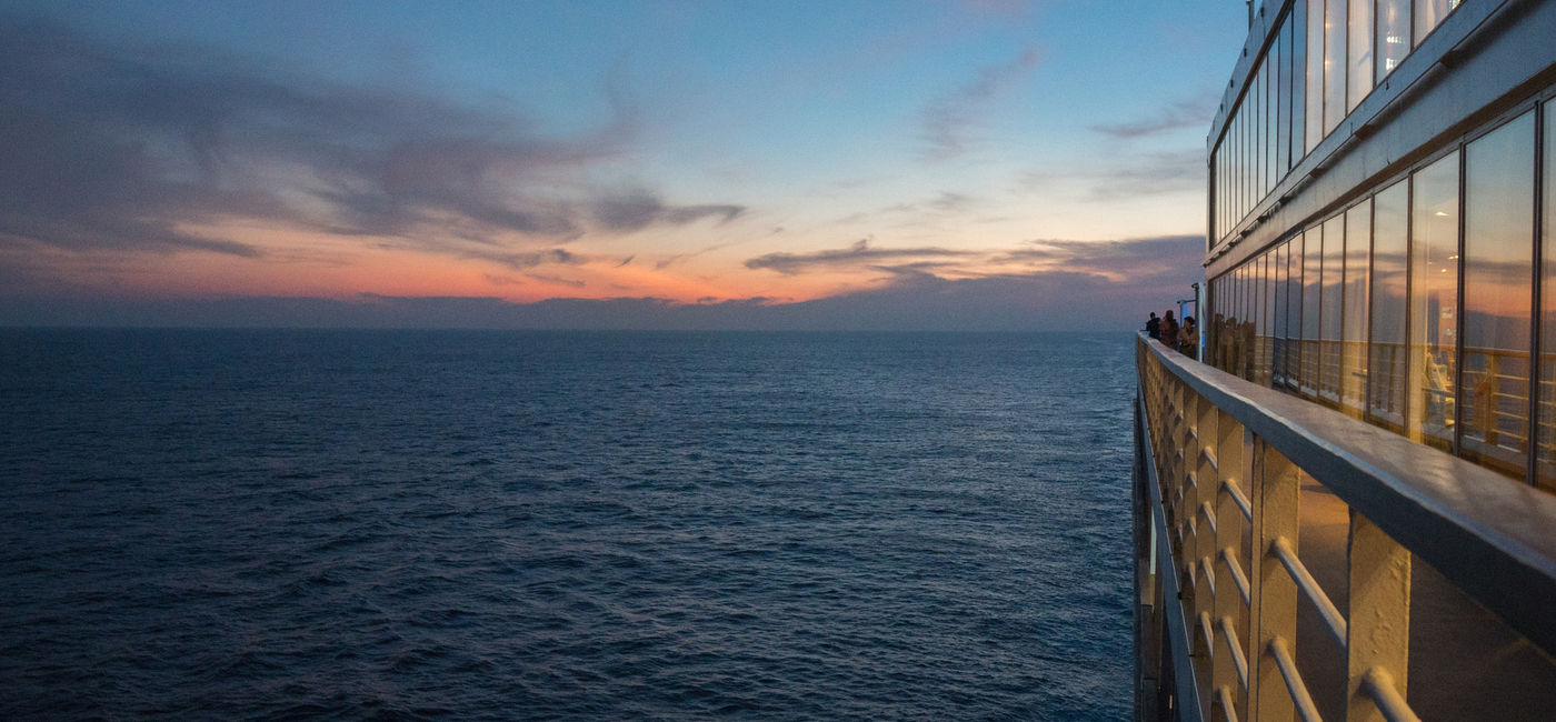 Photo: Deck of cruise ship at sunset. (photo via mgstudyo / iStock / Getty Images Plus)