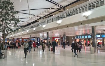 Travelers walking through a terminal at Detroit Metropolitan Airport