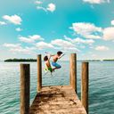 Kids jumping off a dock