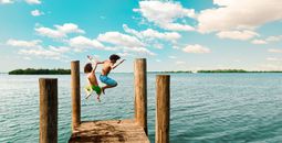 Kids jumping off a dock