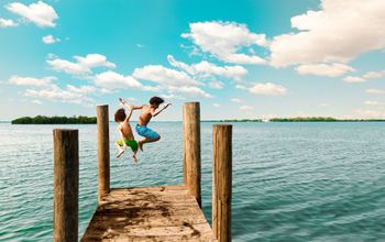 Kids jumping off a dock