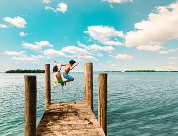 Kids jumping off a dock