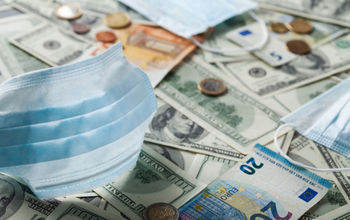 Medical face mask and money from around the world.