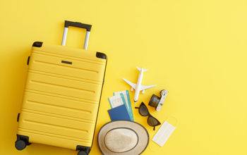 Medical Mask, Suitcase with Sun Hat, Camera, Passport, Airplane Ticket, Sunglasses and Airplane