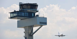 Air traffic control tower and jet aircraft approaching to land