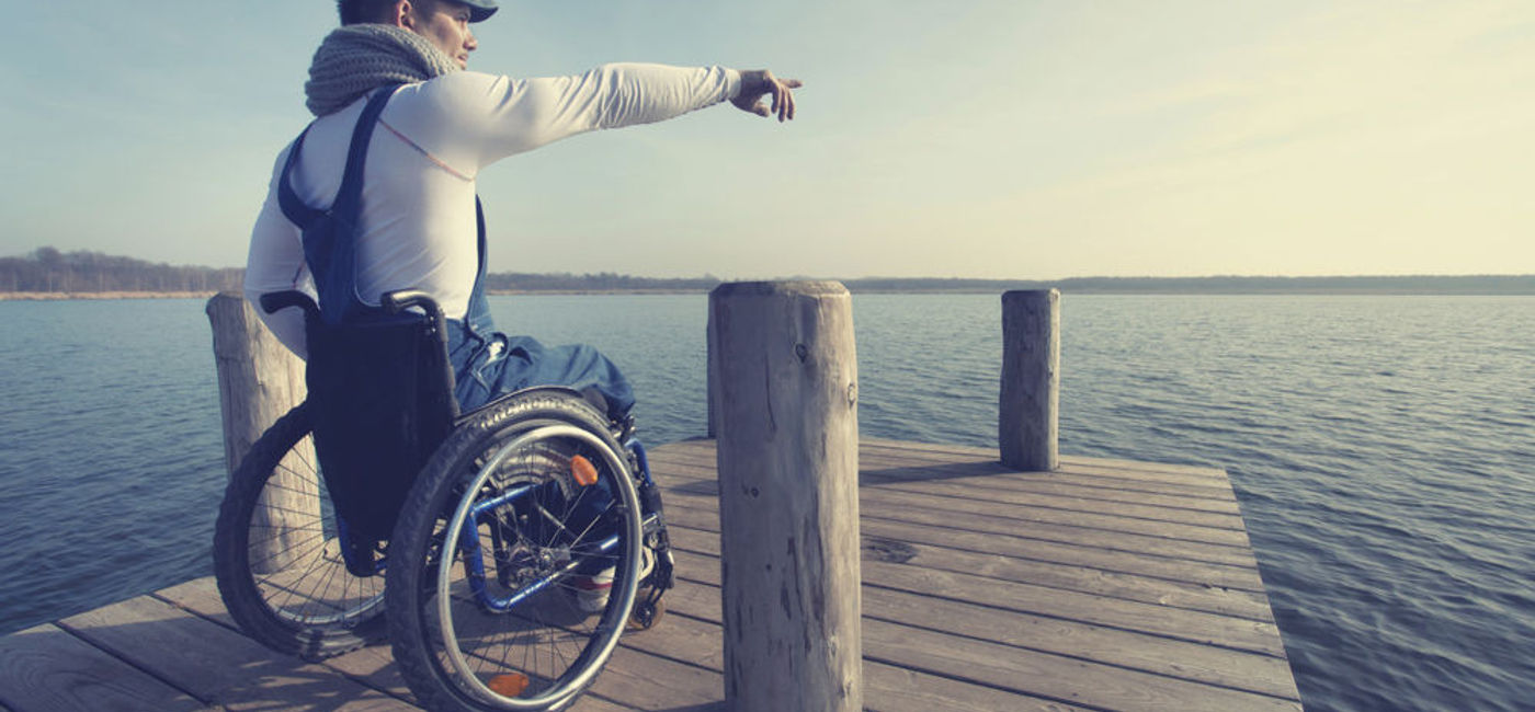 Image: PHOTO: An Individual in a wheelchair points the way forward for accessibility. (photo courtesy of Thinkstock)
