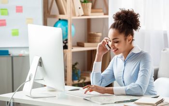 Travel agent working at the computer