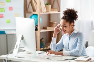 Travel agent working at the computer