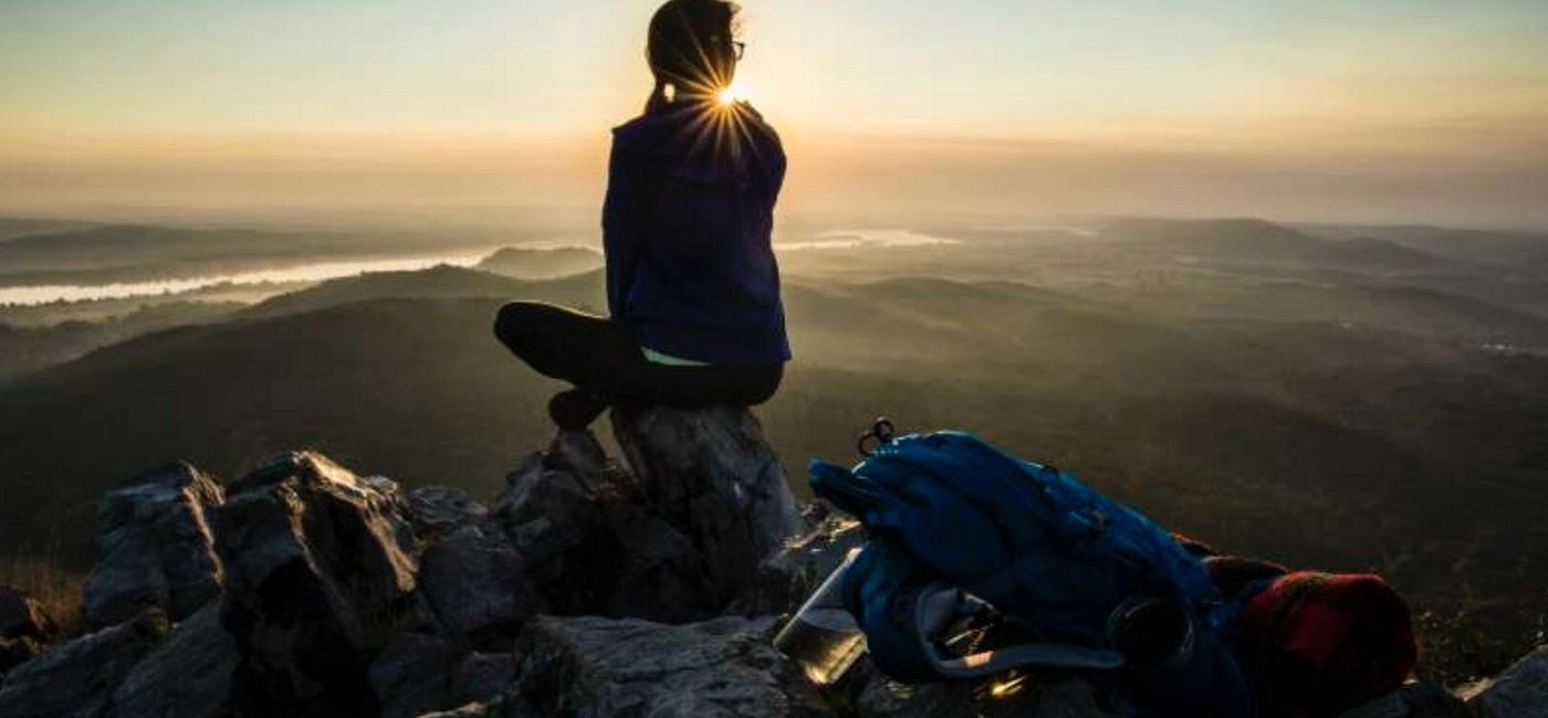 Image: A hiker overlooks the Arkansas River Valley from high atop Pinnacle Mountain State Park. (photo courtesy of Arkansas State Parks)