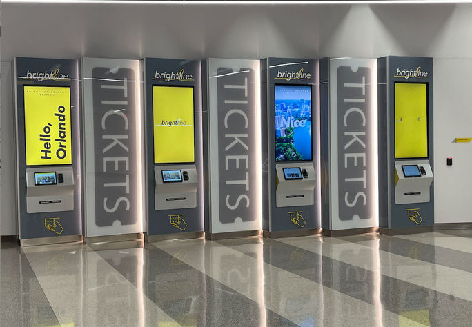 Self-service ticket kiosks at the Brightline Orlando Station.